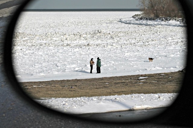 on frozen lake in rearview mirror