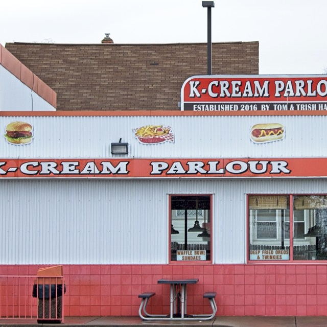 Neighborhood ice cream shop painted orange and white.