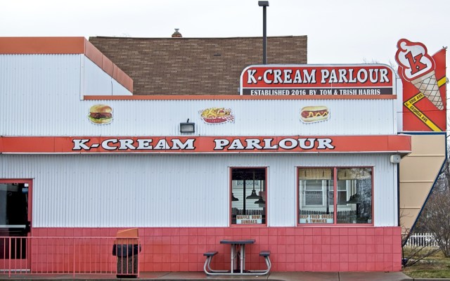 Neighborhood ice cream shop painted orange and white.