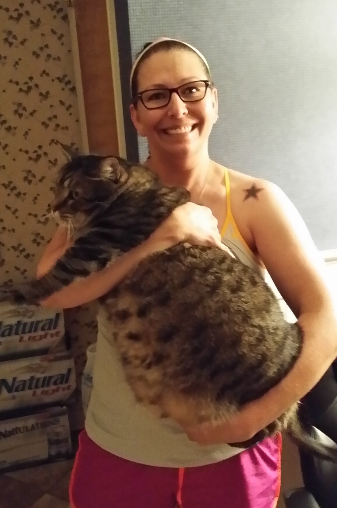 Smiling woman holding extra large cat