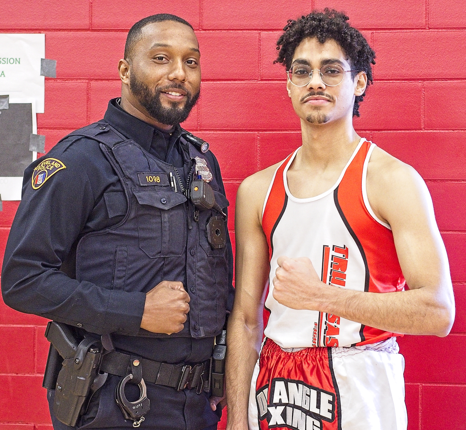 A Cleveland Police officer poses with one of the boxers