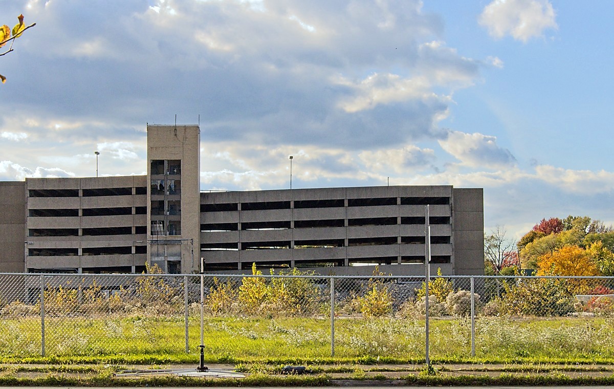 Remnants of an old hospital parking garage serve as the backdrop to a forlorn and forgotten fall landscape. 